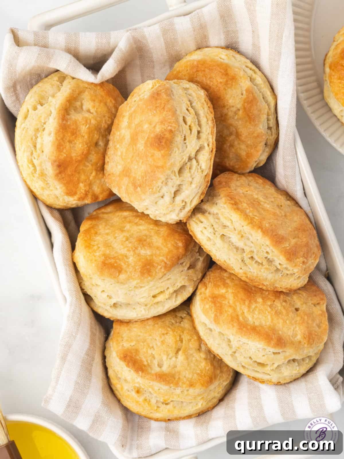 Soft, flaky, and buttery, these Easy Homemade Biscuits are made with just 6 ingredients in 30 minutes. The perfect biscuit recipe! A rustic woven basket filled with an assortment of warm, freshly baked homemade biscuits, ready for serving.