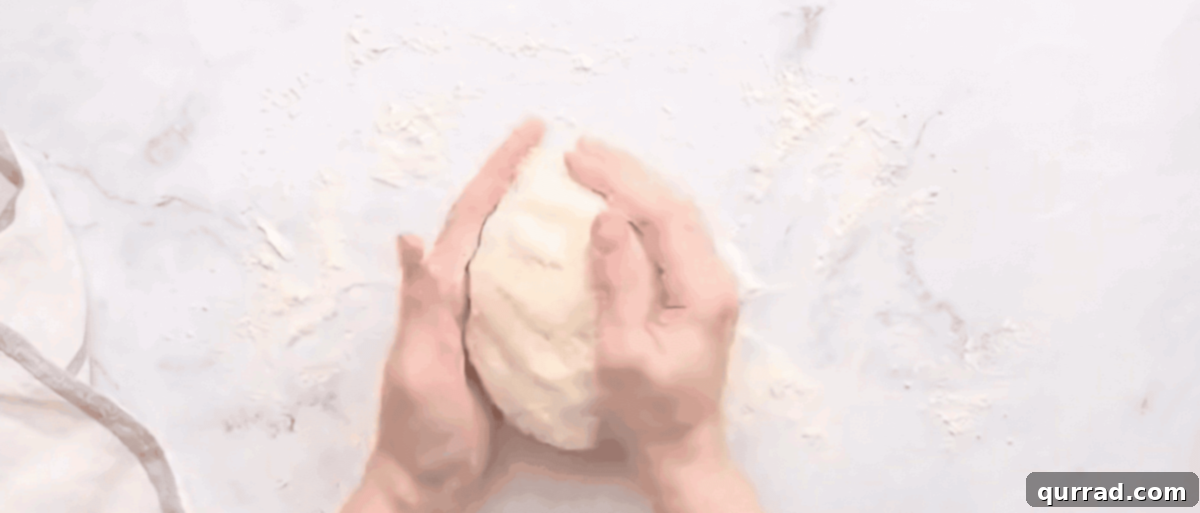 Buttery Flaky Homemade Biscuits 5 A cook gently folding and working the biscuit dough by hand on a floured surface to create tender, flaky layers without overworking.