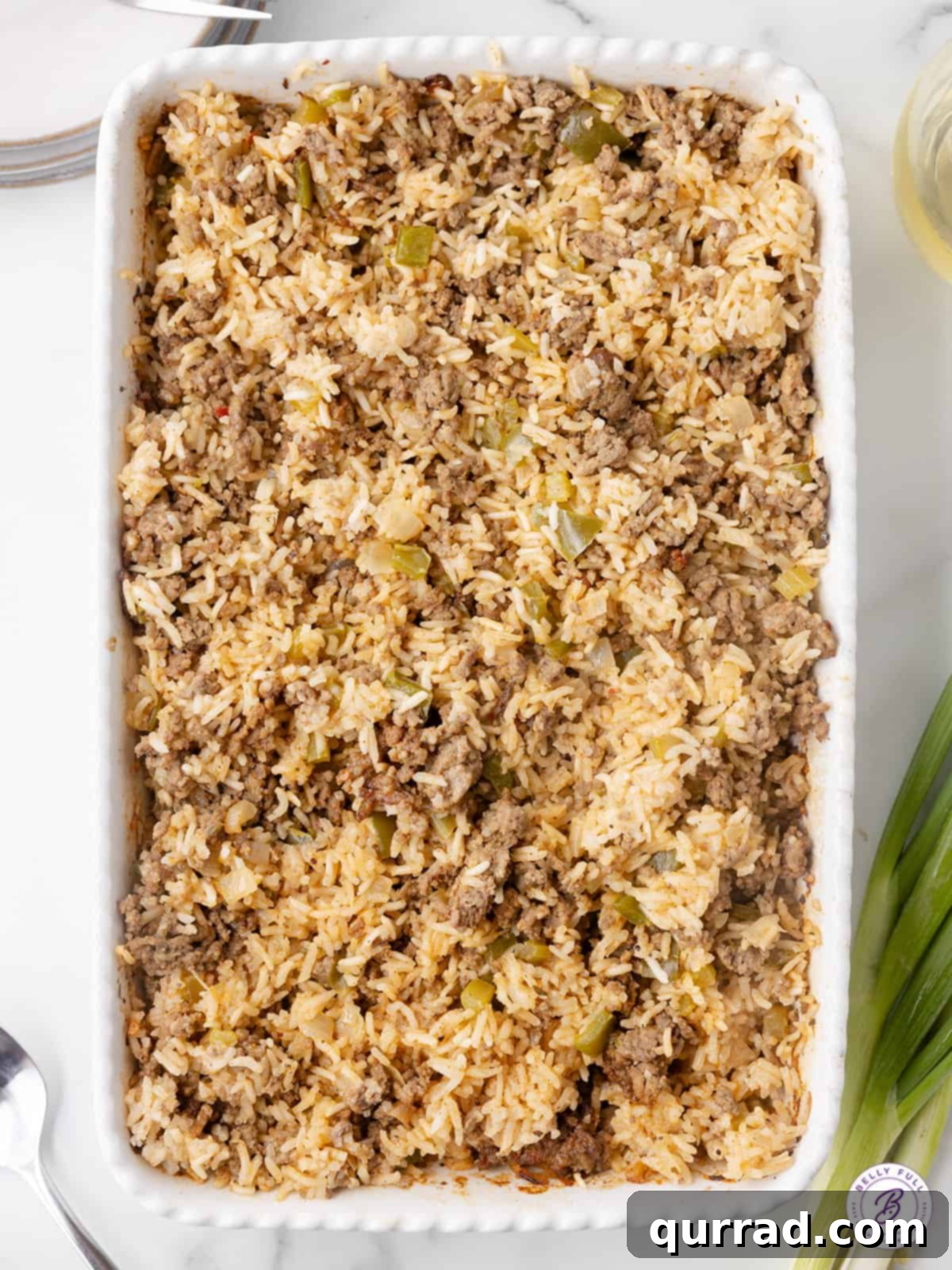 Overhead shot of a delicious dirty rice casserole, perfectly cooked and ready to serve, showcasing its rich brown color and hearty texture.