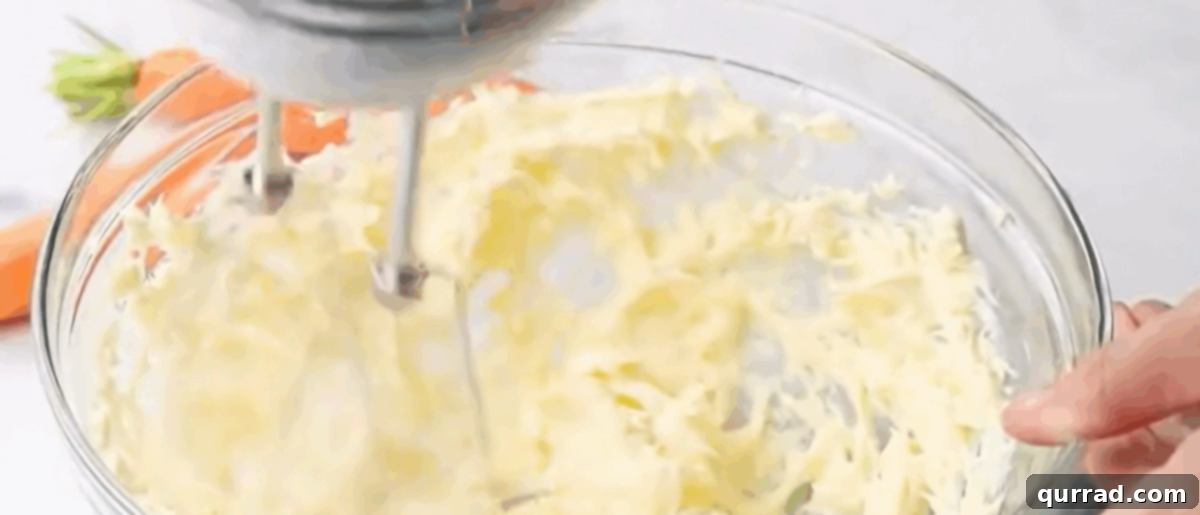 Spiced Carrot Cake Roulade 9 Mixing softened cream cheese, butter, powdered sugar, and vanilla extract to create a smooth, fluffy frosting.