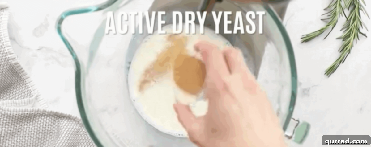 Soft Buttery Folded Rolls 2 Activating the yeast for the rolls in a large glass measuring cup.
