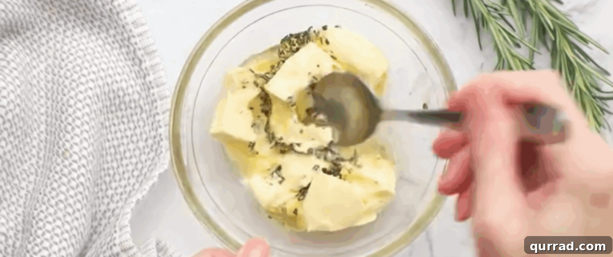 Soft Buttery Folded Rolls 4 Combining butter, honey and rosemary in a glass bowl.