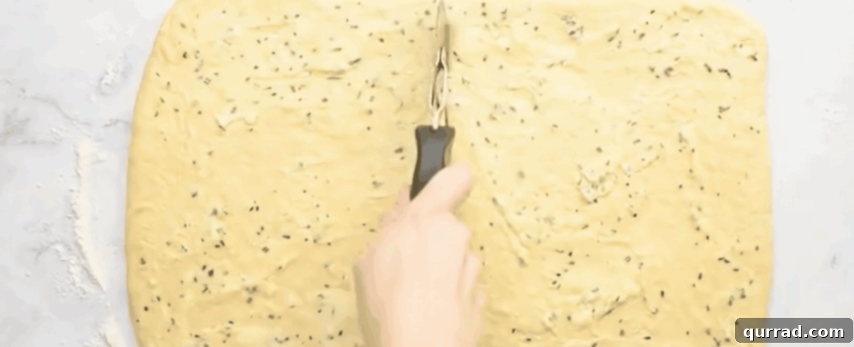 Soft Buttery Folded Rolls 5 Spreading the filling over the dough and cutting the dough with a pizza cutter.