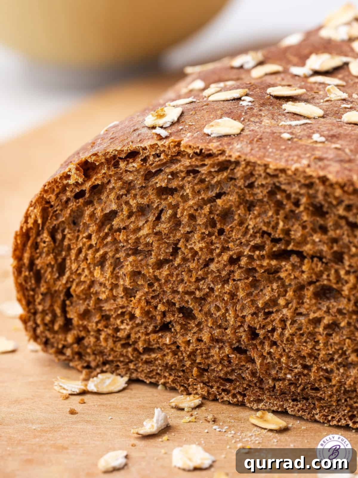 Close up of a warm, inviting loaf of brown bread, highlighting its rustic crust and tender interior.