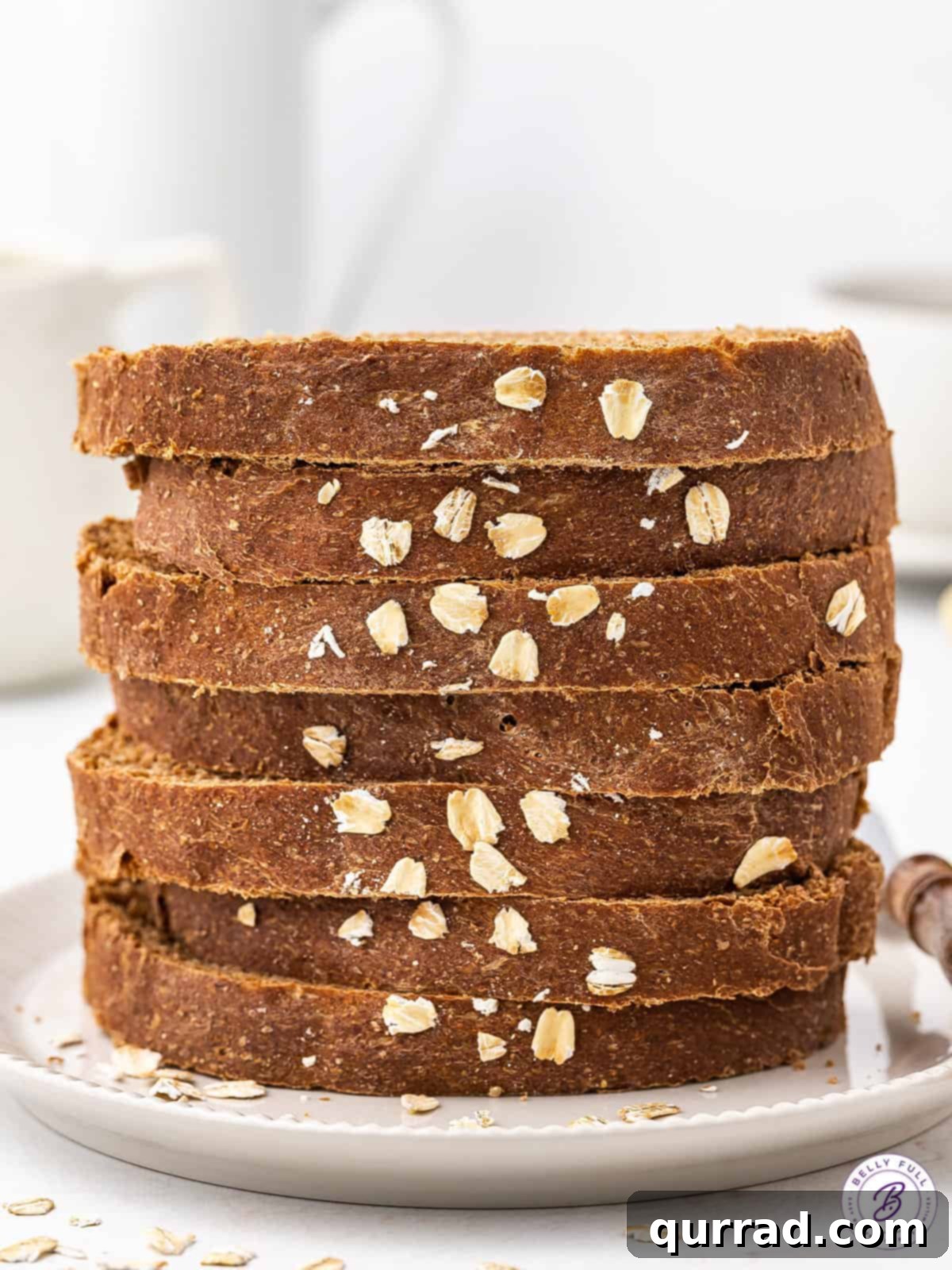A stack of perfectly sliced brown bread, ready to be served or savored.