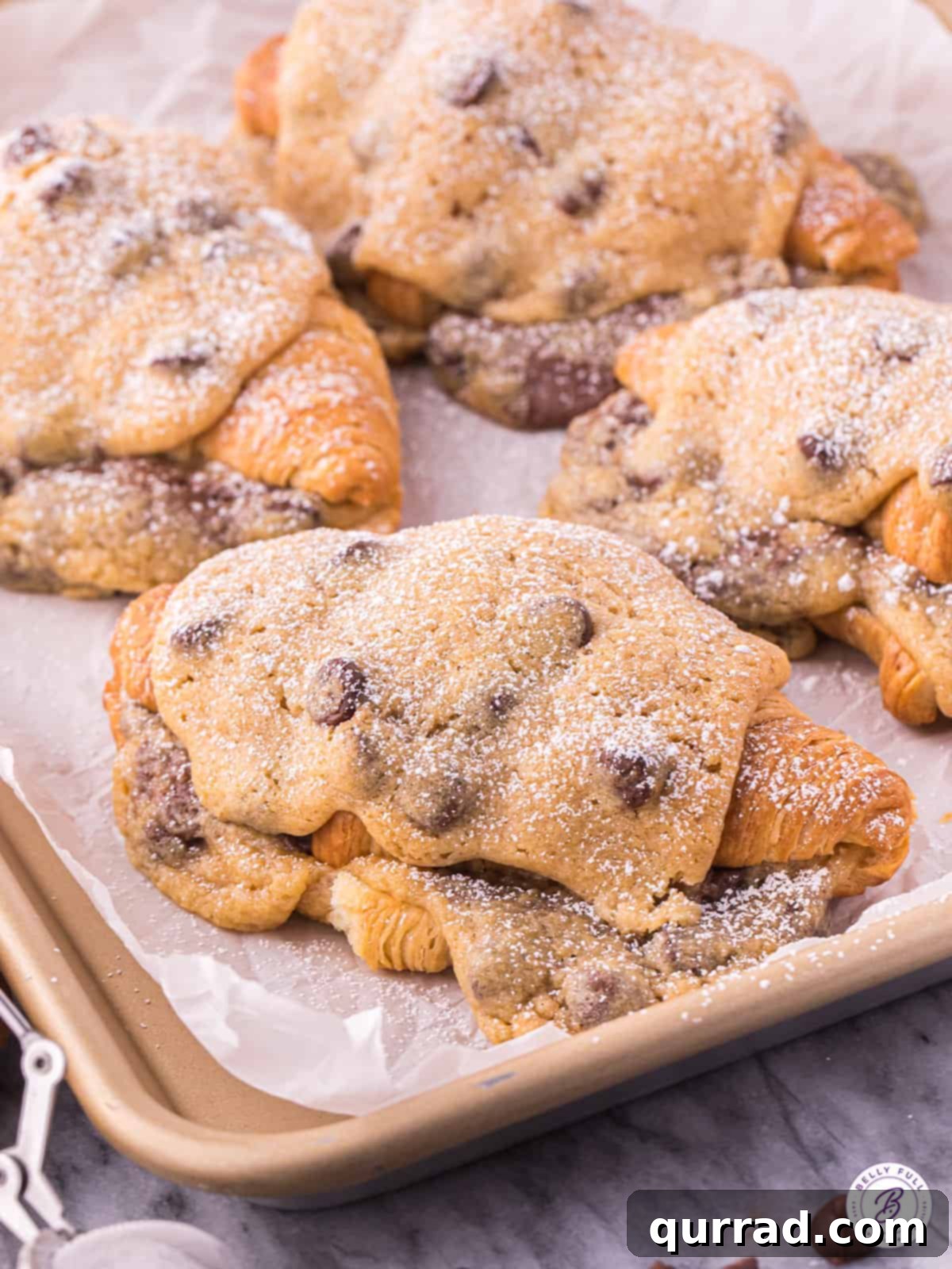 4 cookie croissants on baking sheet