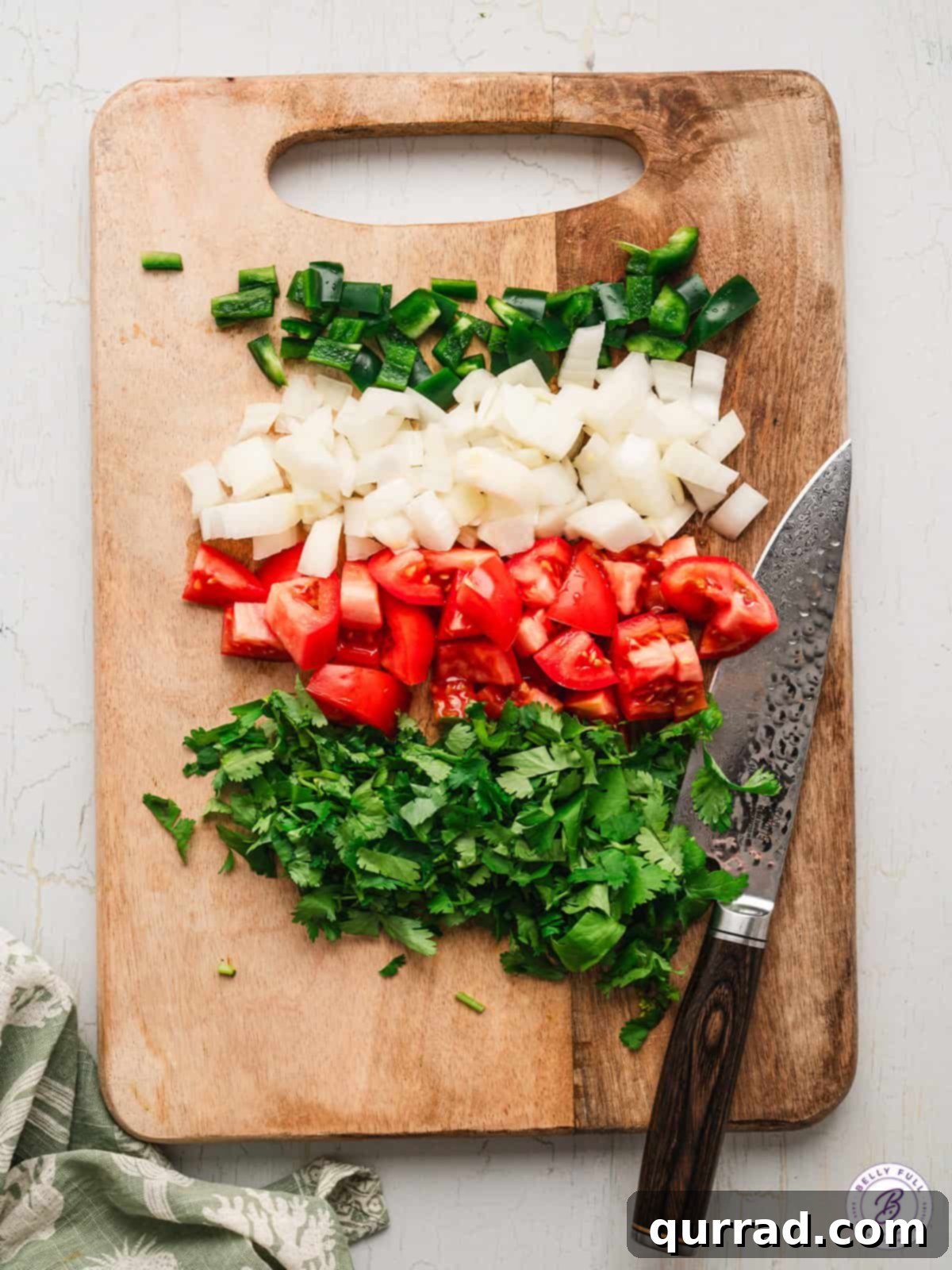 Classic Red Salsa 3 Close-up of freshly chopped Roma tomatoes, white onion, jalapeño, and cilantro on a cutting board, ready for blending into Salsa Roja.