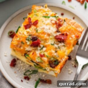 A slice of an egg bake with bagels on a plate