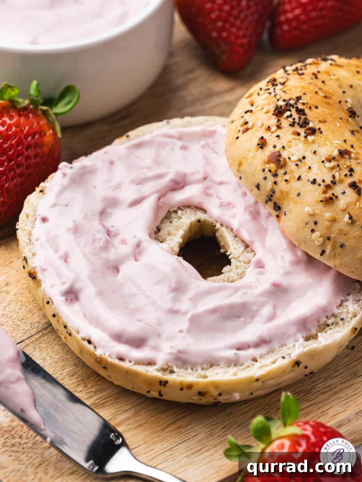 Made with fresh strawberries and powdered sugar, Strawberry Cream Cheese is light and fluffy with the perfect balance of sweet & tart flavors. Strawberry cream cheese generously spread on a toasted bagel, garnished with a fresh strawberry slice.