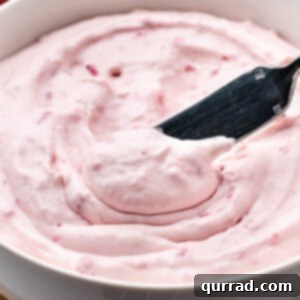Luscious Strawberry Cream Cheese 2 A knife diving into a bowl of strawberry cream cheese