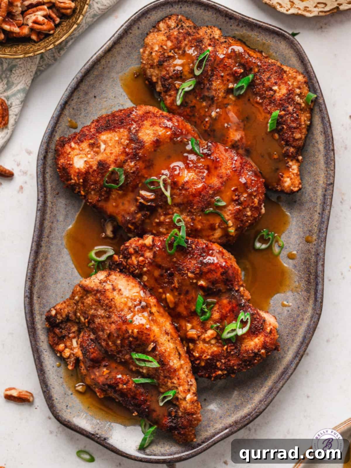 Bourbon pecan chicken arranged artfully on a platter, ready to be served.