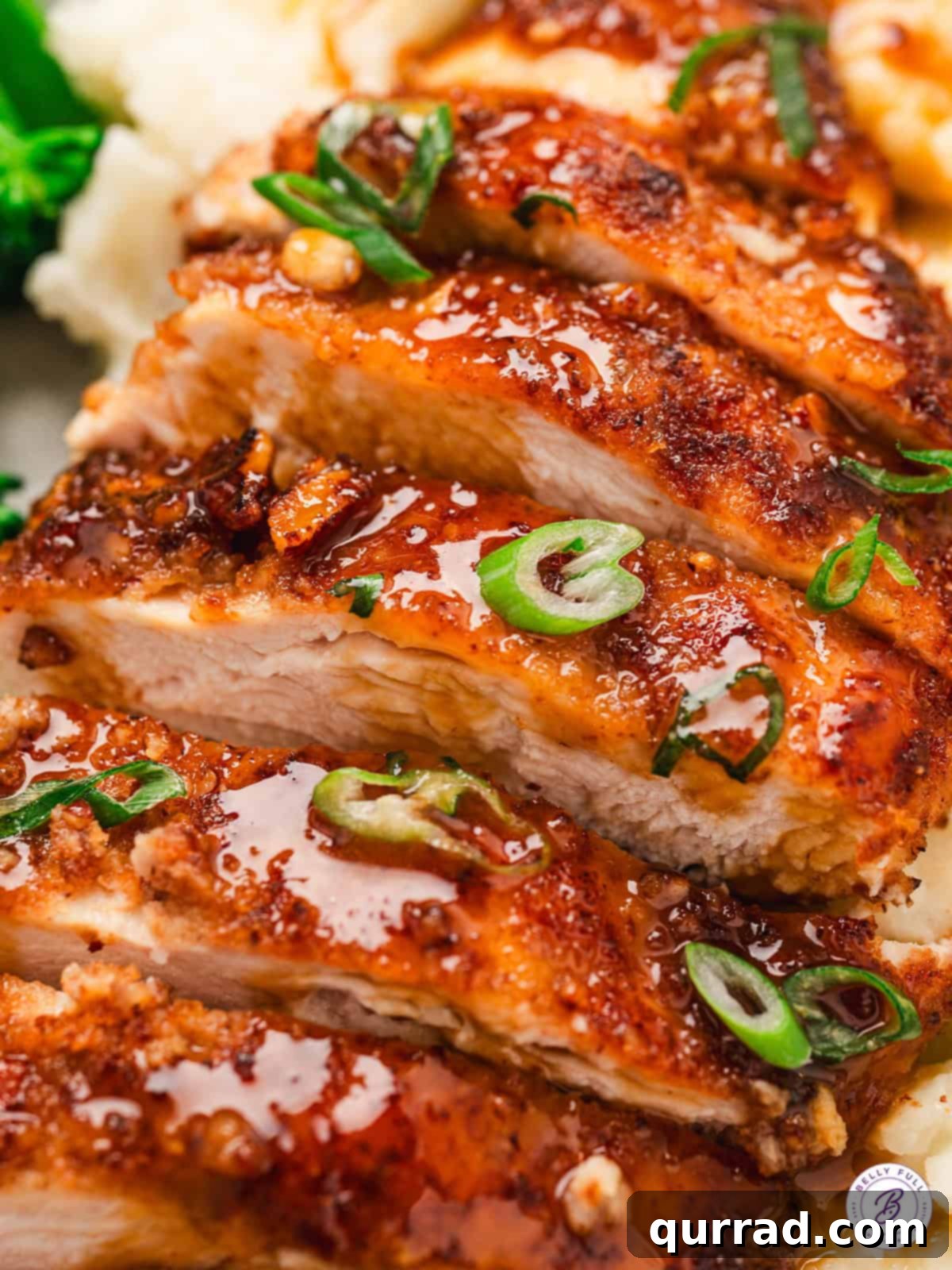 An overhead view of sliced bourbon pecan chicken, revealing the juicy meat and inviting pecan crust.