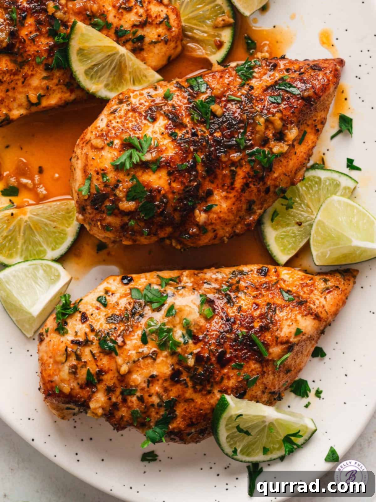 This Garlic Lime Chicken is generously seasoned then sauteed in fresh lime juice and garlic for perfectly tender & juicy chicken. Two chili lime chicken breasts on a white platter