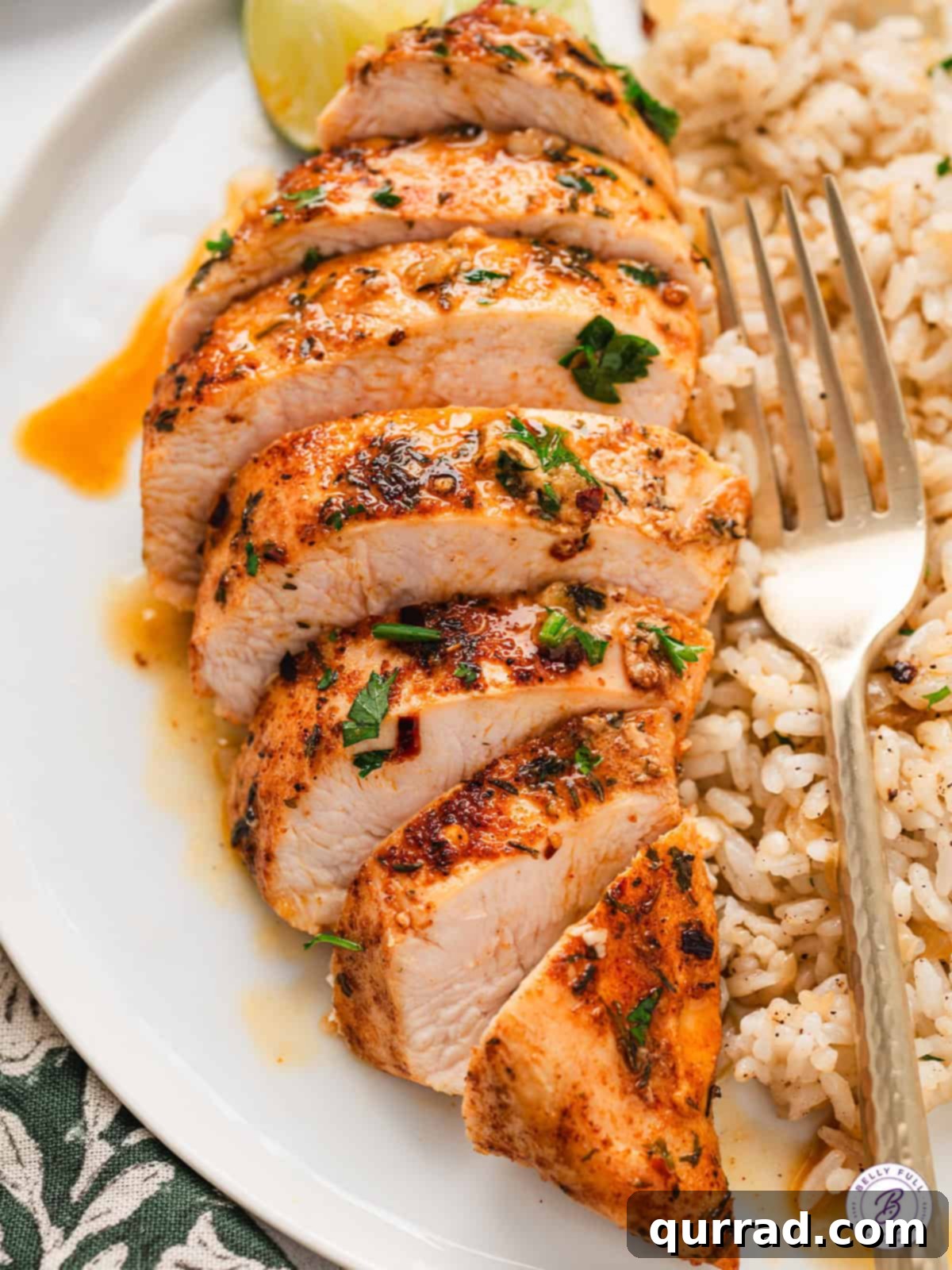 This Garlic Lime Chicken is generously seasoned then sauteed in fresh lime juice and garlic for perfectly tender & juicy chicken. Sliced garlic lime chicken on a plate