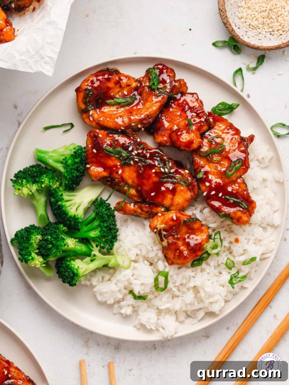 With honey, soy sauce, brown sugar, and sriracha, Sweet & Spicy Sticky Chicken offers the perfect balance of flavor & texture. A perfectly plated serving of sweet & spicy sticky chicken alongside fluffy white rice and vibrant roasted broccoli.