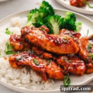 A plate of sweet sticky spicy chicken with rice and broccoli
