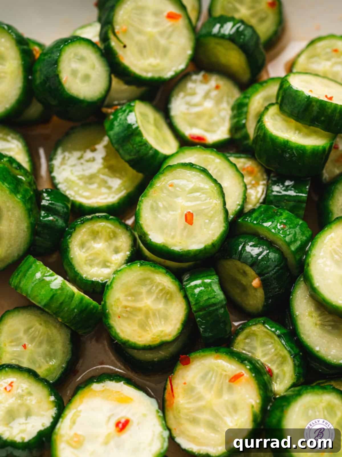 Zesty Asian Cucumber Crunch 5 Close-up shot of sliced marinated Asian cucumbers, showcasing their texture and how well they absorb the dressing.