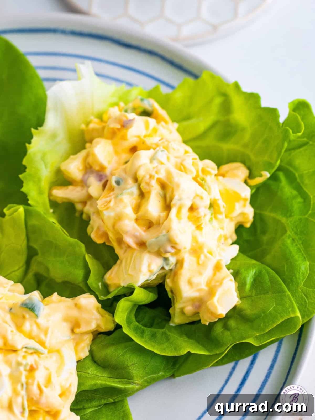 Pimento Cheese Egg Salad on Lettuce Pimento cheese egg salad served beautifully on fresh lettuce leaves, ready to be enjoyed.