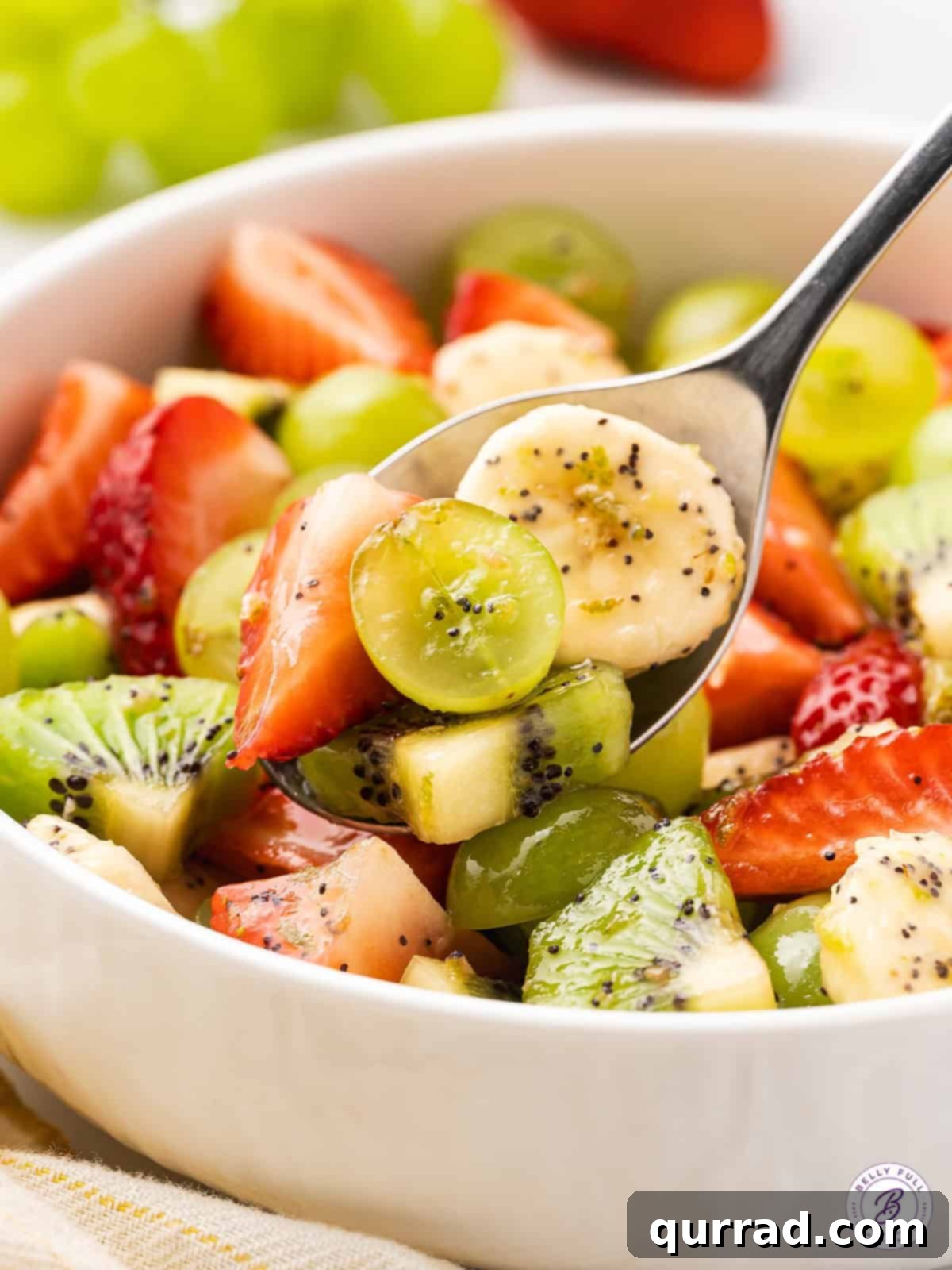 Vibrant Honey-Lime Fruit Medley 4 spoonful of fresh fruit with poppy seed dressing