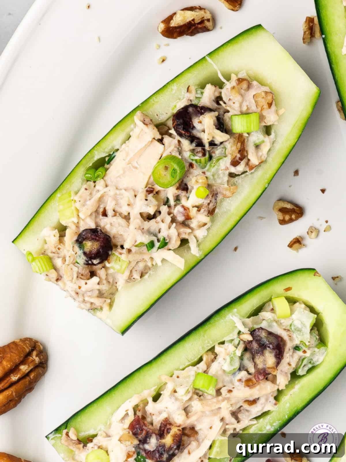Light Chicken Salad Cucumber Boats 2 Overhead view of perfectly arranged chicken salad cucumber boats, ready to serve
