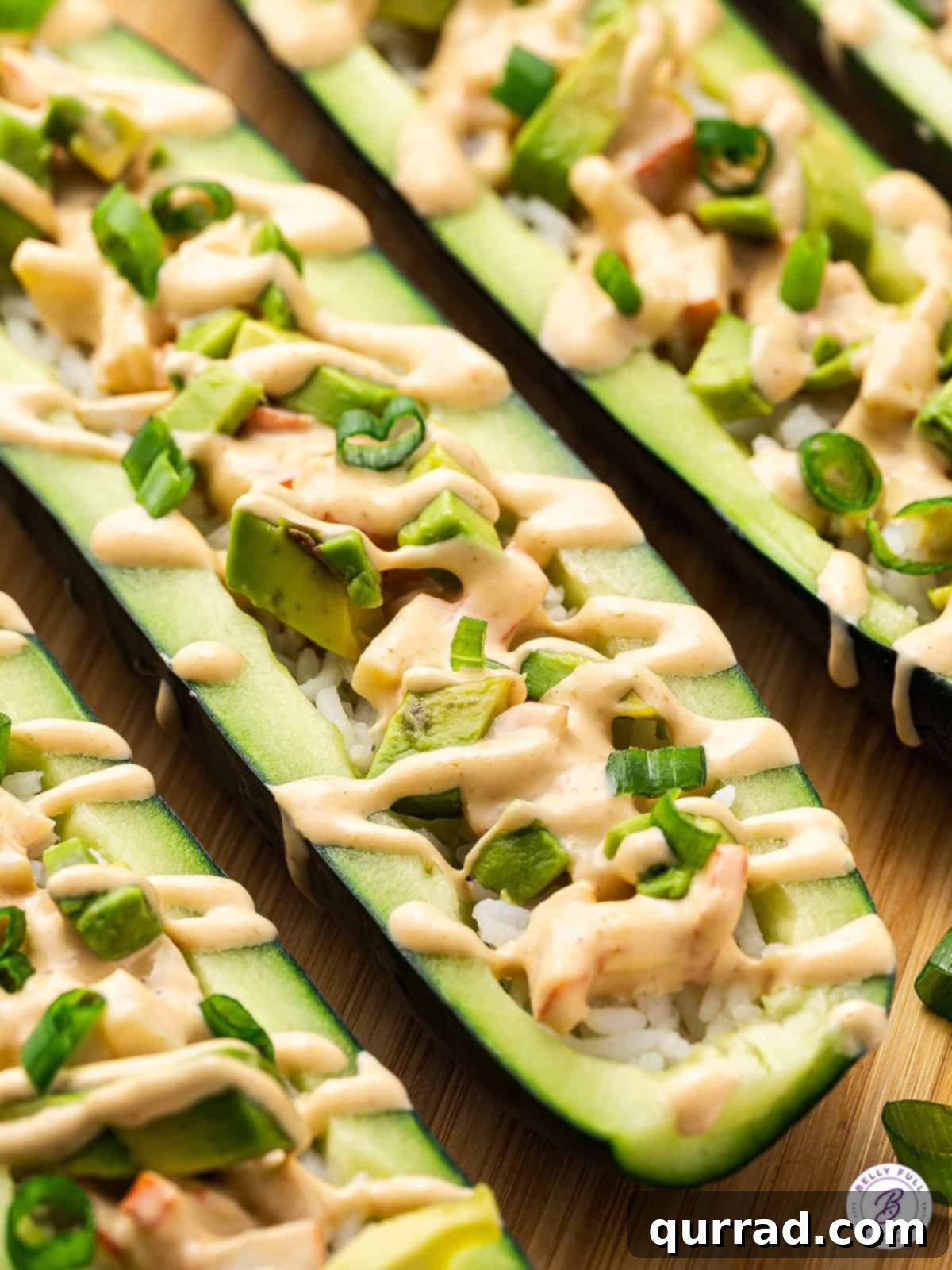 A close-up view highlighting the fresh ingredients and appealing presentation of cucumber sushi boats. Close-up detail of beautifully garnished cucumber sushi boats ready to be served, showcasing the fresh avocado, spicy crab, and scallion toppings.