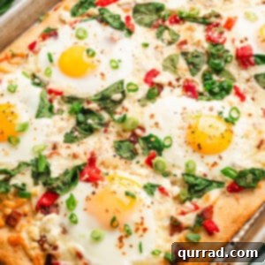 Overhead view of breakfast pizza with eggs