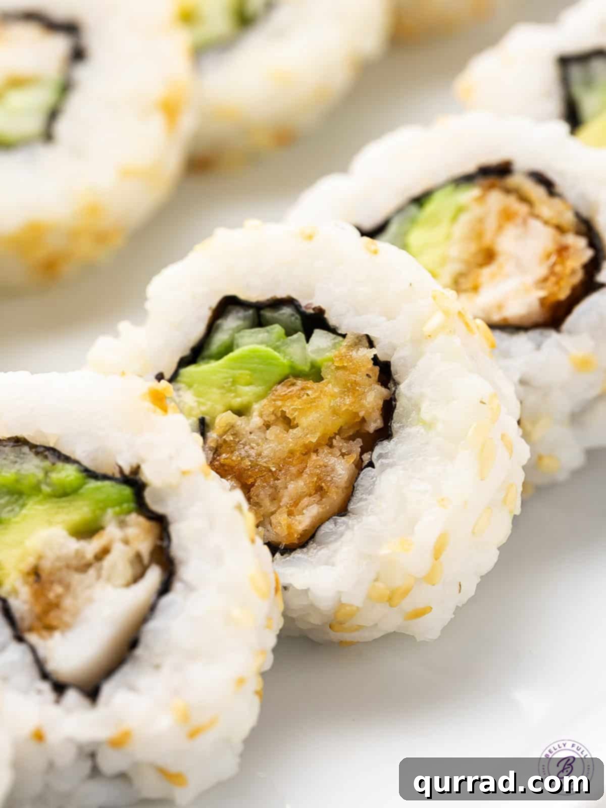 Made with frozen fish sticks, avocado, and cucumber, these Fish Stick Sushi Rolls are a quick, easy, and cheap way to make sushi at home. Close up of pieces of fish stick sushi rolls