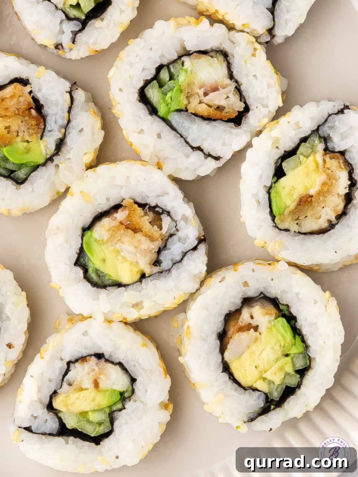 Made with frozen fish sticks, avocado, and cucumber, these Fish Stick Sushi Rolls are a quick, easy, and cheap way to make sushi at home. Pieces of fish finger sushi rolls on a plate