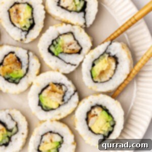 Crispy Fish Sushi Bites 2 Chopsticks grabbing a piece of a fish finger sushi roll from a plate