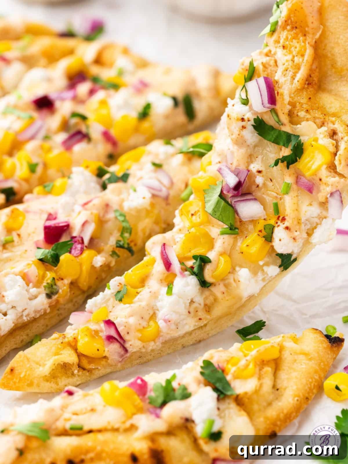 With a seasoned Mexican crema sauce, corn kernels, red onions, and lots of cheese, this Mexican Street Corn Flatbread is a fun appetizer. Picking up a slice of Mexican street corn flatbread