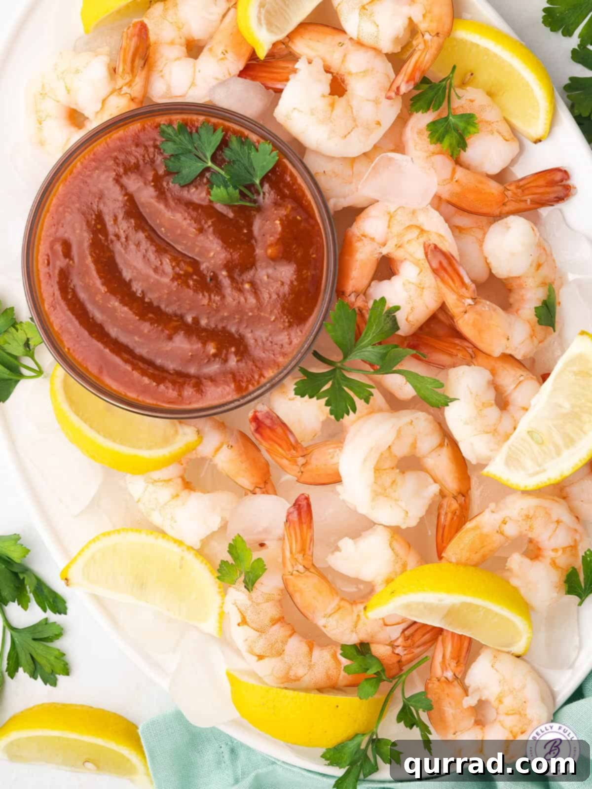 Serve this versatile cocktail sauce with all your favorite seafood dishes. Overhead view of shrimp with a dish of homemade cocktail sauce