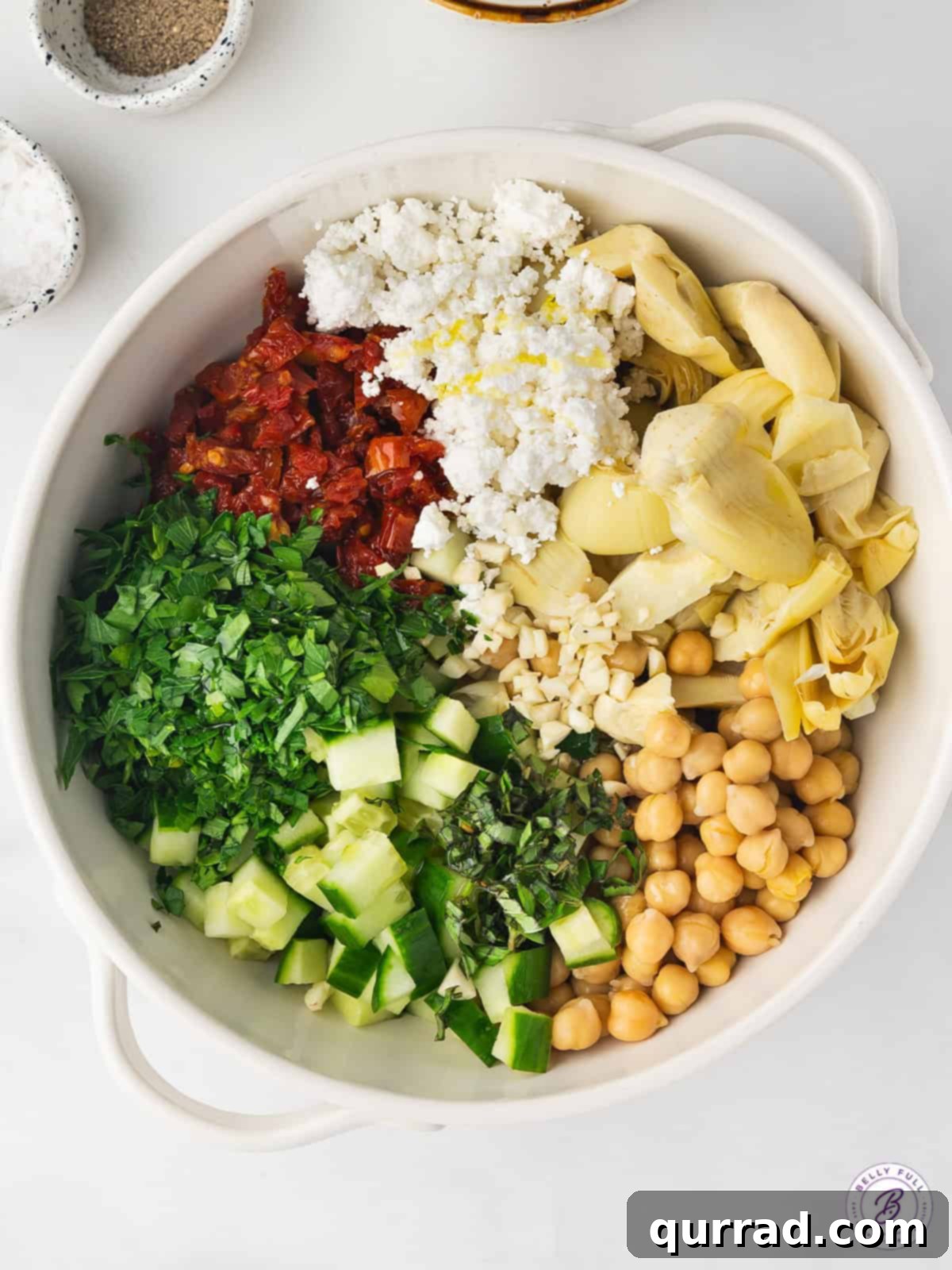 This Chickpea Salad and Cottage Cheese Toast features creamy cottage cheese on a thick slice of toast topped with a savory chickpea salad. Chickpea salad ingredients in a bowl