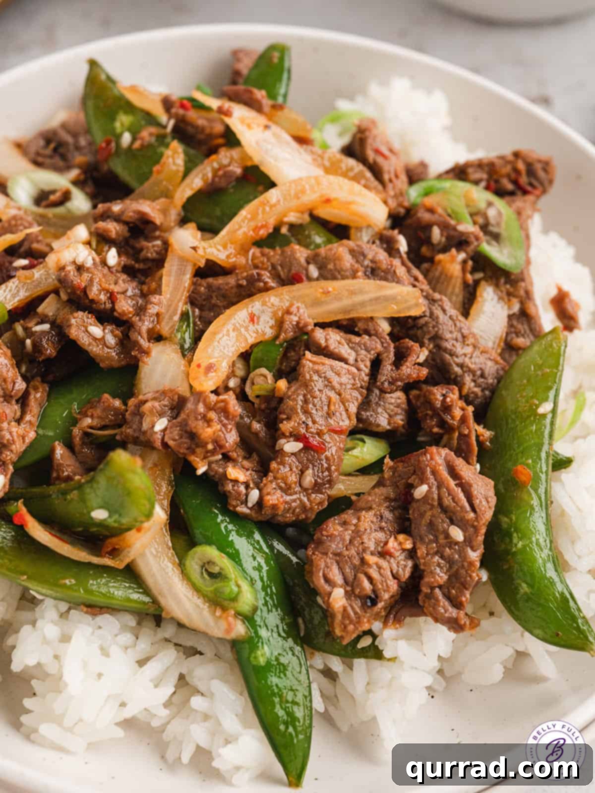 Grilled Peanut Chicken Skewers 4 Korean beef bulgogi with colorful peppers and snap peas served over a bed of white rice.