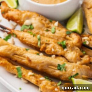 Chicken satay skewers on a plate