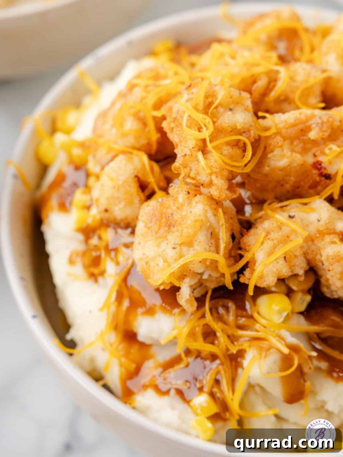 Close up of a KFC mashed potato bowl, showing the layers of ingredients