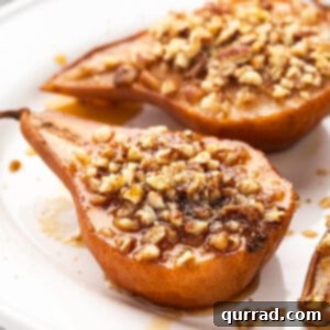 Warm Pear Delight 2 Close-up of baked pear halves arranged in a baking dish, drizzled with honey-spice mixture and topped with chopped pecans, ready for the oven.
