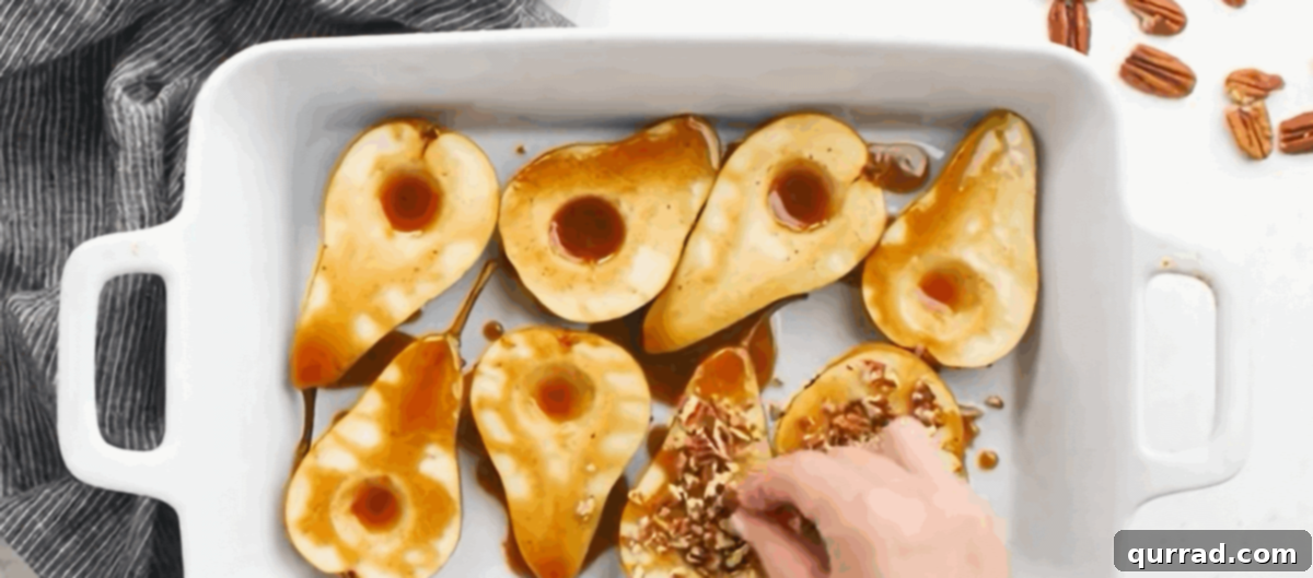 Warm Pear Delight 4 Prepared pear halves nestled in a white casserole dish, generously drizzled with a rich honey mixture and topped with crunchy chopped pecans, ready to be baked to golden perfection.