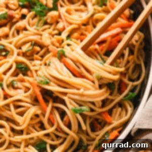 Chopsticks in a bowl of peanut noodles