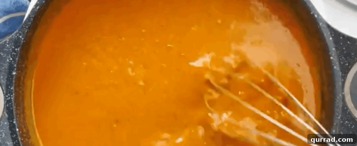 Rich Hungarian Paprika Chicken 7 Adding the sour cream and heavy cream mixture thickened with flour to the simmering paprikash sauce.
