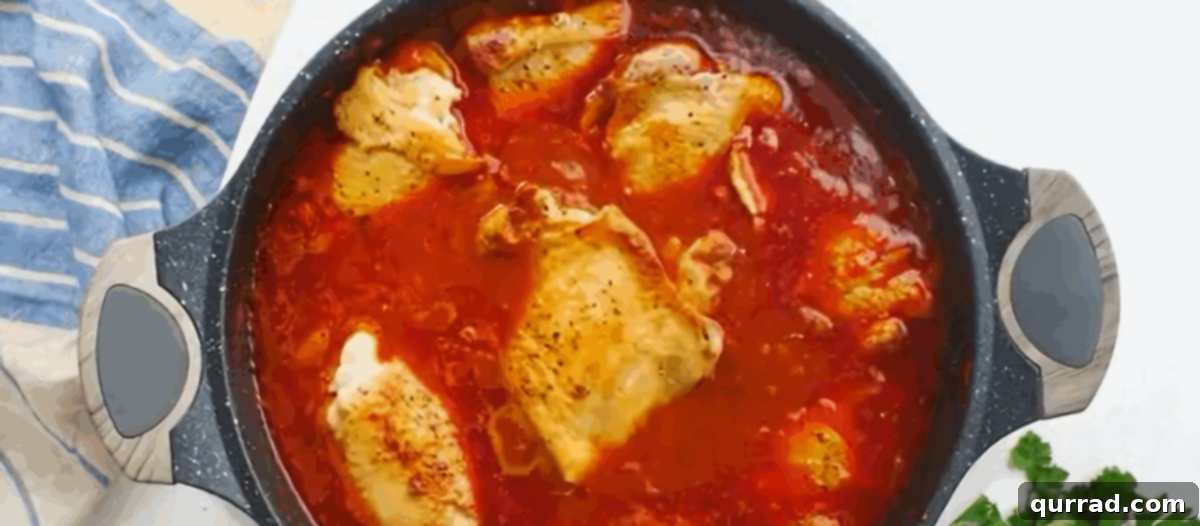 Rich Hungarian Paprika Chicken 6 Adding the browned chicken back to the pot with the simmering sauce for cooking.