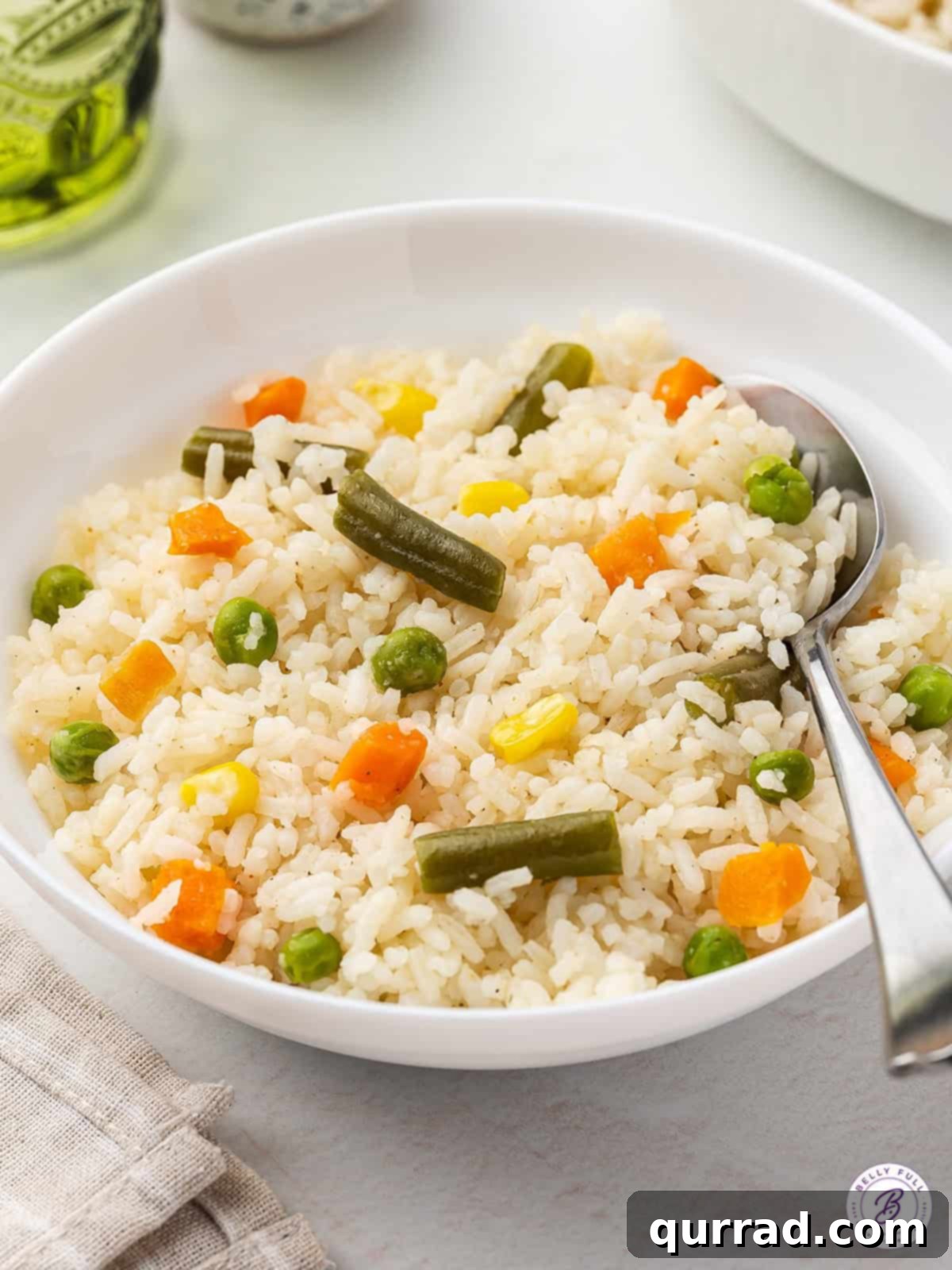 Fluffy white rice and frozen veggies are lightly seasoned and buttered in this Mixed Veggies and Rice recipe. A beautifully presented bowl of mixed vegetable rice, garnished and ready to be enjoyed as a wholesome side.