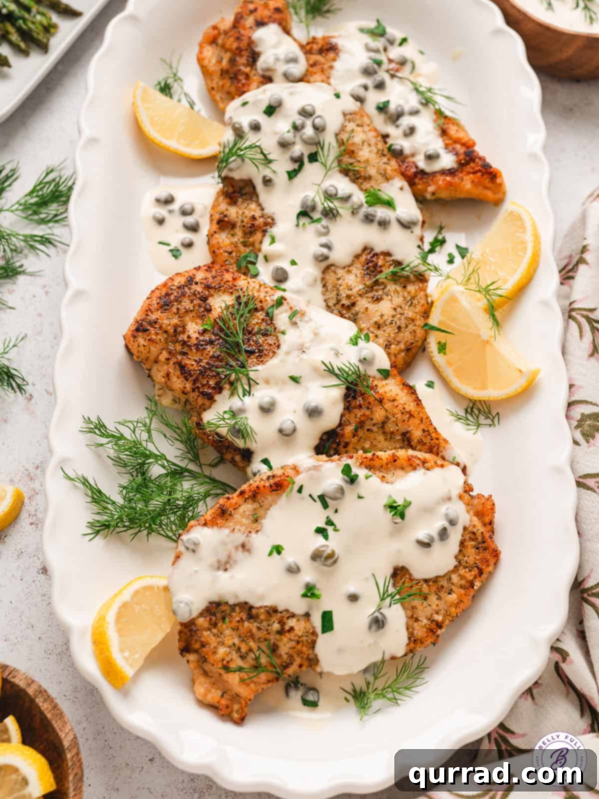 Platter of Chicken with Caper Cream Sauce A large platter showcasing multiple chicken pieces coated in the savory caper cream sauce, ready for serving.