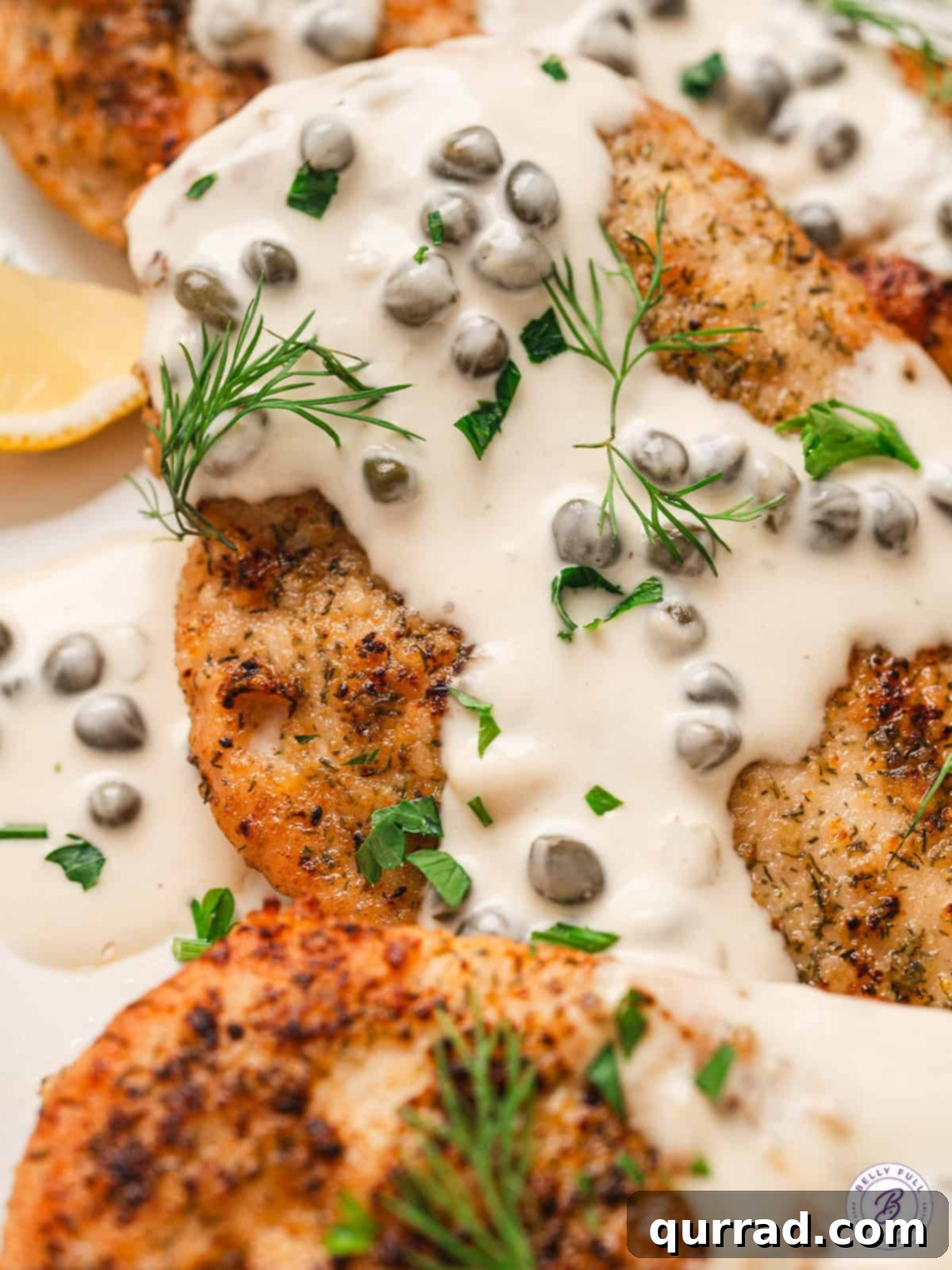 Overhead view of Chicken with Caper Cream Sauce An overhead shot revealing perfectly cooked chicken bathed in a creamy, golden caper sauce, garnished with fresh herbs.