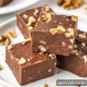 A close up of a stack of fudge on a white plate.