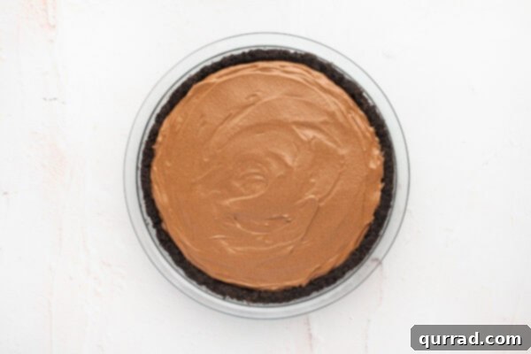An Oreo pie crust filled with the luscious French silk pie filling, smoothed and ready for chilling.