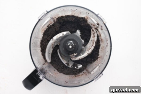 Crushed Oreos in a food processor, transformed into fine, uniform crumbs for the pie crust.