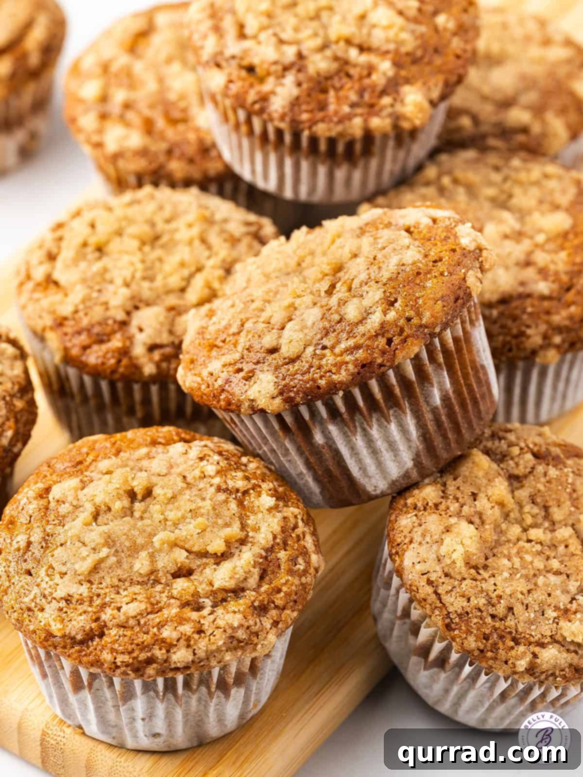 Overhead view of a pile of banana crumb muffins with a coffee cup