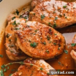 Pork chops with apple cider glaze in a skillet