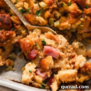 Close up of a spoon in a dish of Ham and Gruyere stuffing