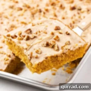 Serving a slice of pumpkin sheet cake from the pan